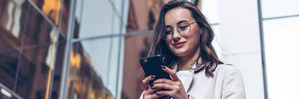 woman on her phone utilizing ebs mobile applications