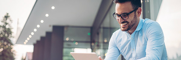 man in blue shirt smiling about cloud capabilities