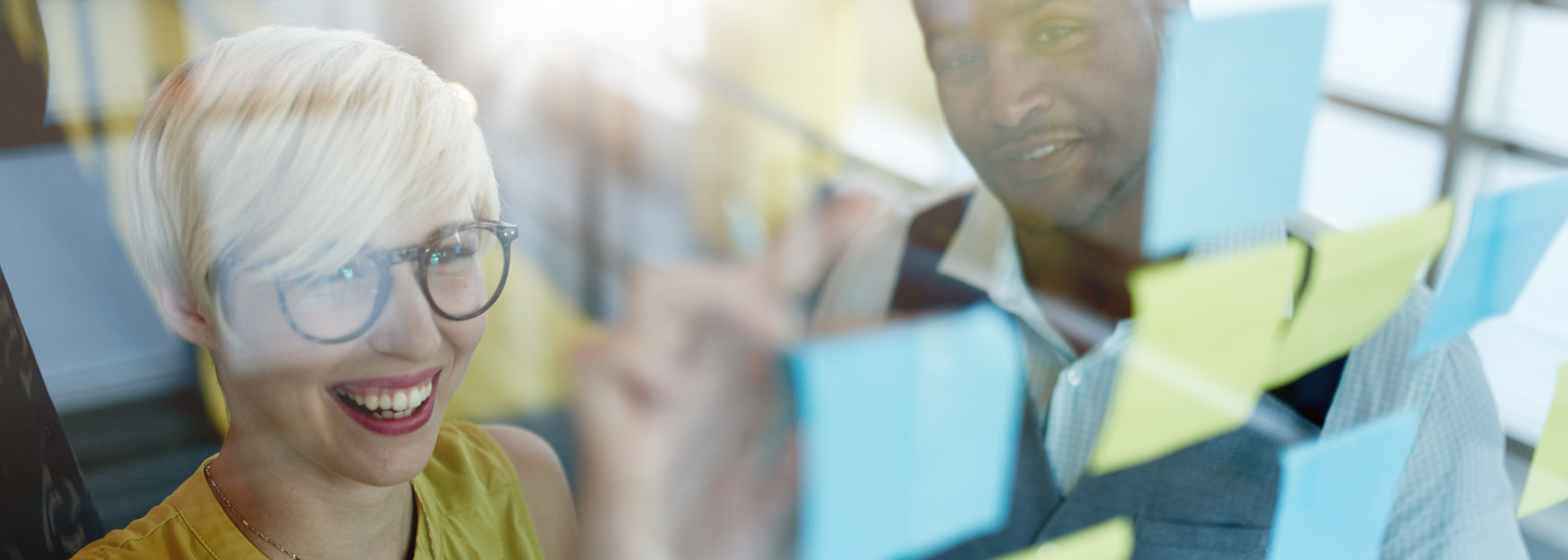 woman with glasses smiling about how SAP's support of sustainability feeds the circular economy