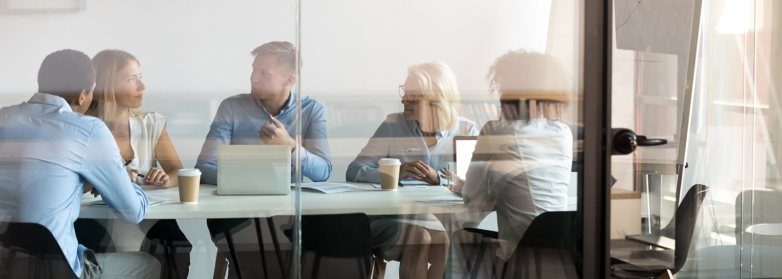 several coworkers in a meeting talking about oracle e business suite release