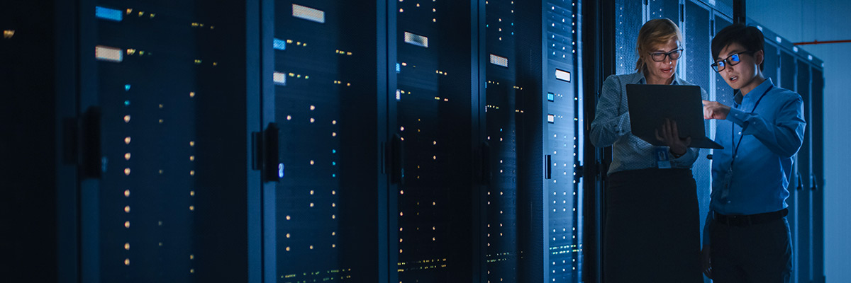 two employees working in a server room