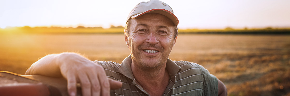 man in field looking at camera