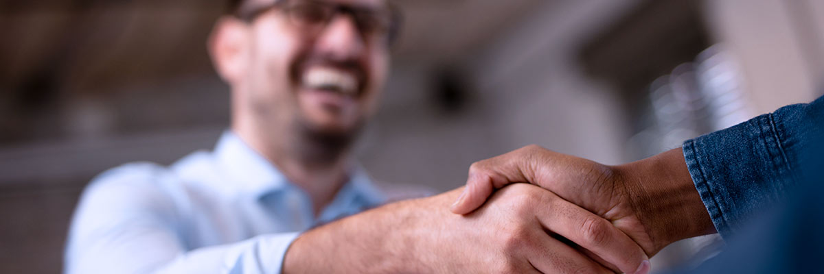 two people shaking hands over agreement