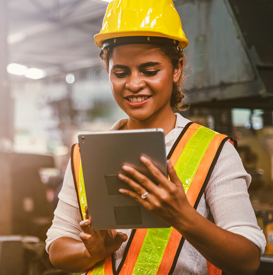 Woman wearing safety gear in an operations facility.