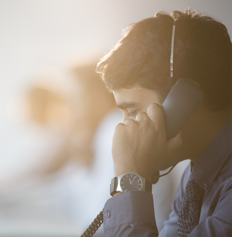 proserv Man speaking into a phone handset.