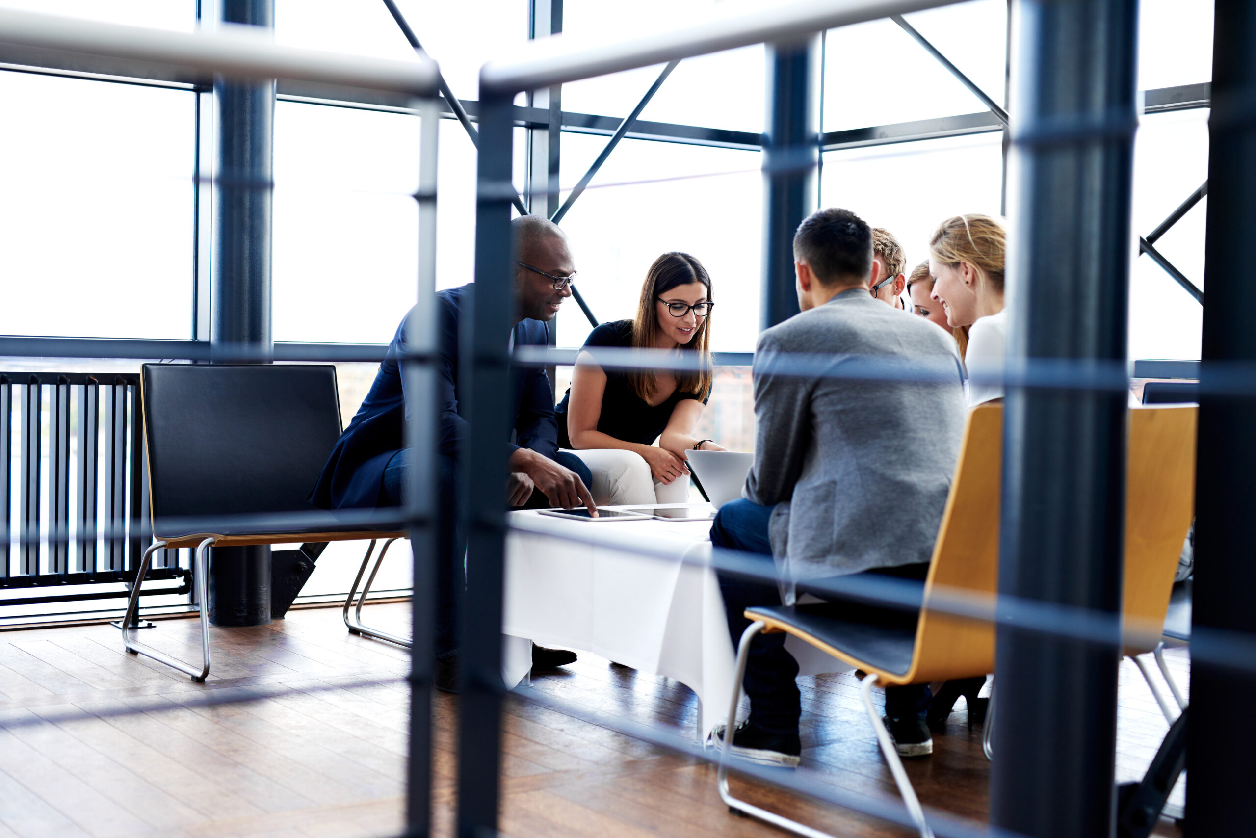 group of executives sitting together and working Team of IT professionals collaborating on enterprise solutions, symbolizing personalized support and cloud modernization for IBM i (AS/400) systems.